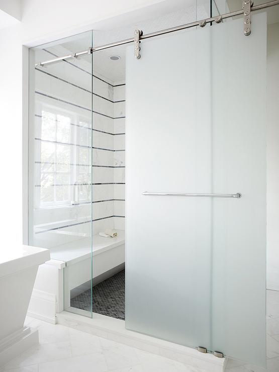 frosted-glass-sliding-shower-door-on-rails-black-white-striped-tiles